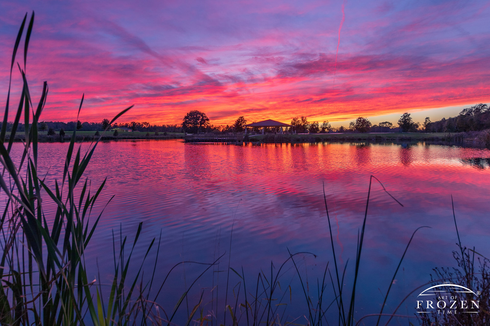 A colorful twilight over Feldman Pond at Centerville Ohio's Oak Grove park. Clouds that previously provided grey skies at sunset, ignitied in vibrant colors at sunset creating a perfect image for Centerville Fine Art Photography