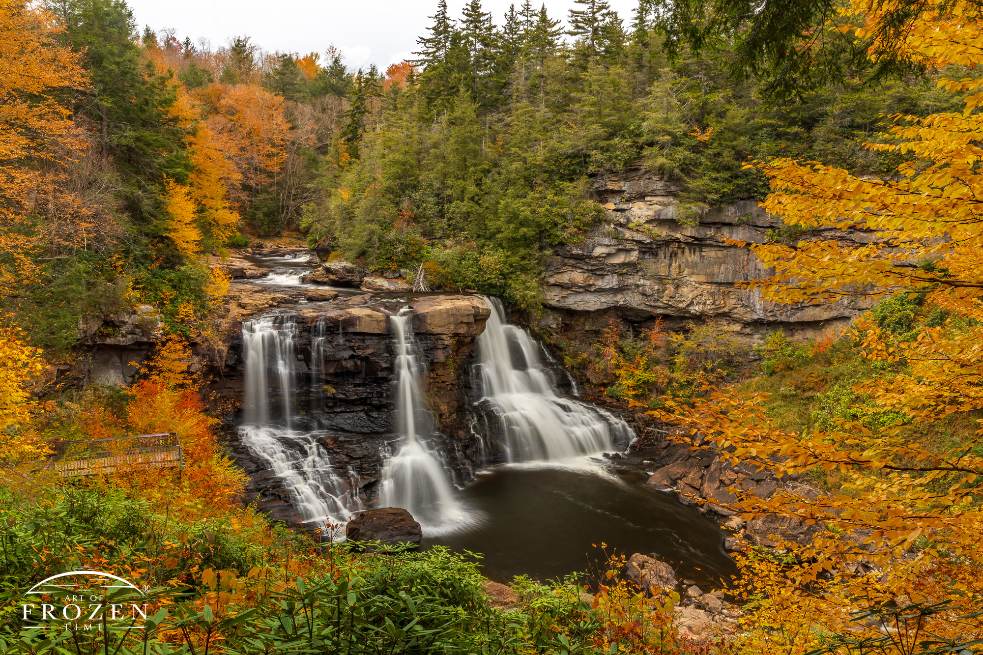 A dramatic West Virginia waterfall where the Black River spills over a formation 60 feet into a pool of water as autumn color filled the surrounding forest.