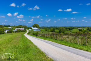 Fine art photography of a country road running through Brown County Ohio and under clear blue skies