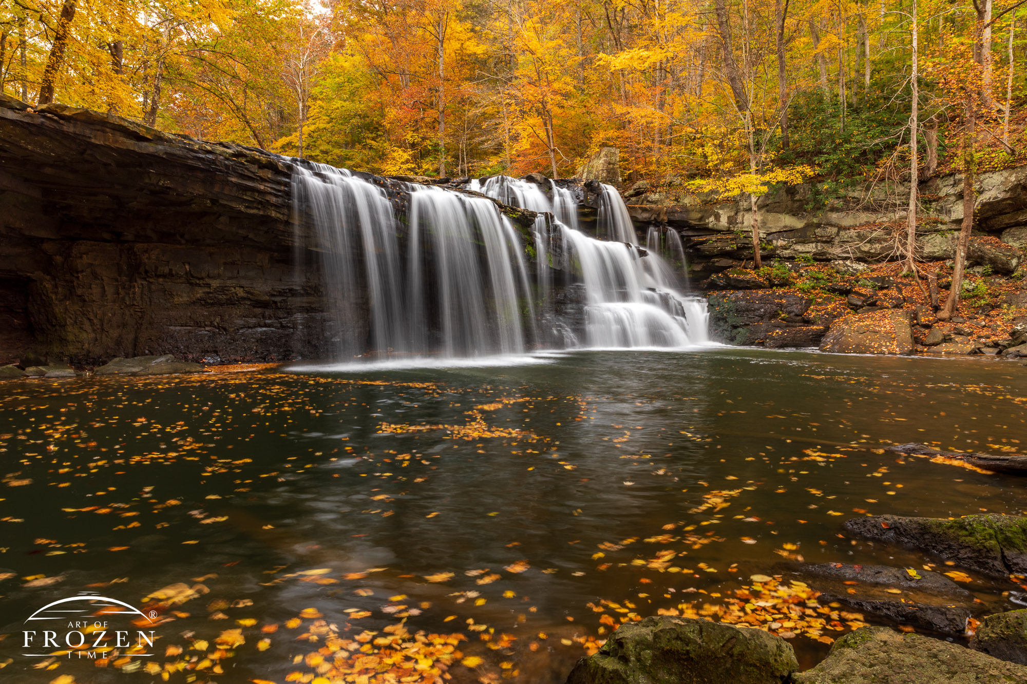 Brush Creek Falls surrounded by autumn-colored leaves where a long exposure rendered the falls with a silky texture