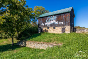 The Hamilton County Ohio Bicentennial Barn with the sunlight illuminating the red, white and blue logo under blue Ohio skies