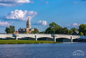 Miami County Courthouse in Troy, Ohio, viewed from Treasure Island across the Great Miami River and Adams Street Bridge under September cumulus clouds.