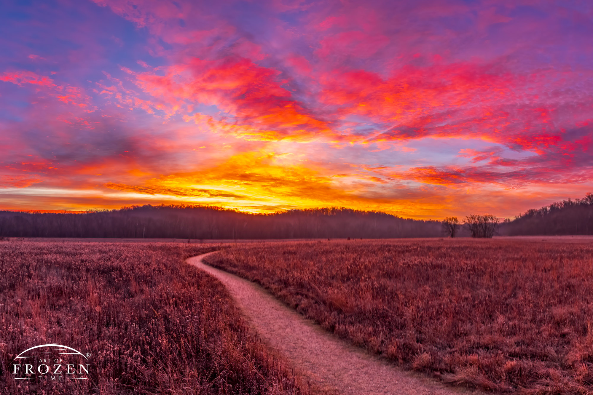 A prairie footpath meandering to the horizon under the amazing skies of a winter sunrise at Morris Reserve, near Bellbrook, Ohio