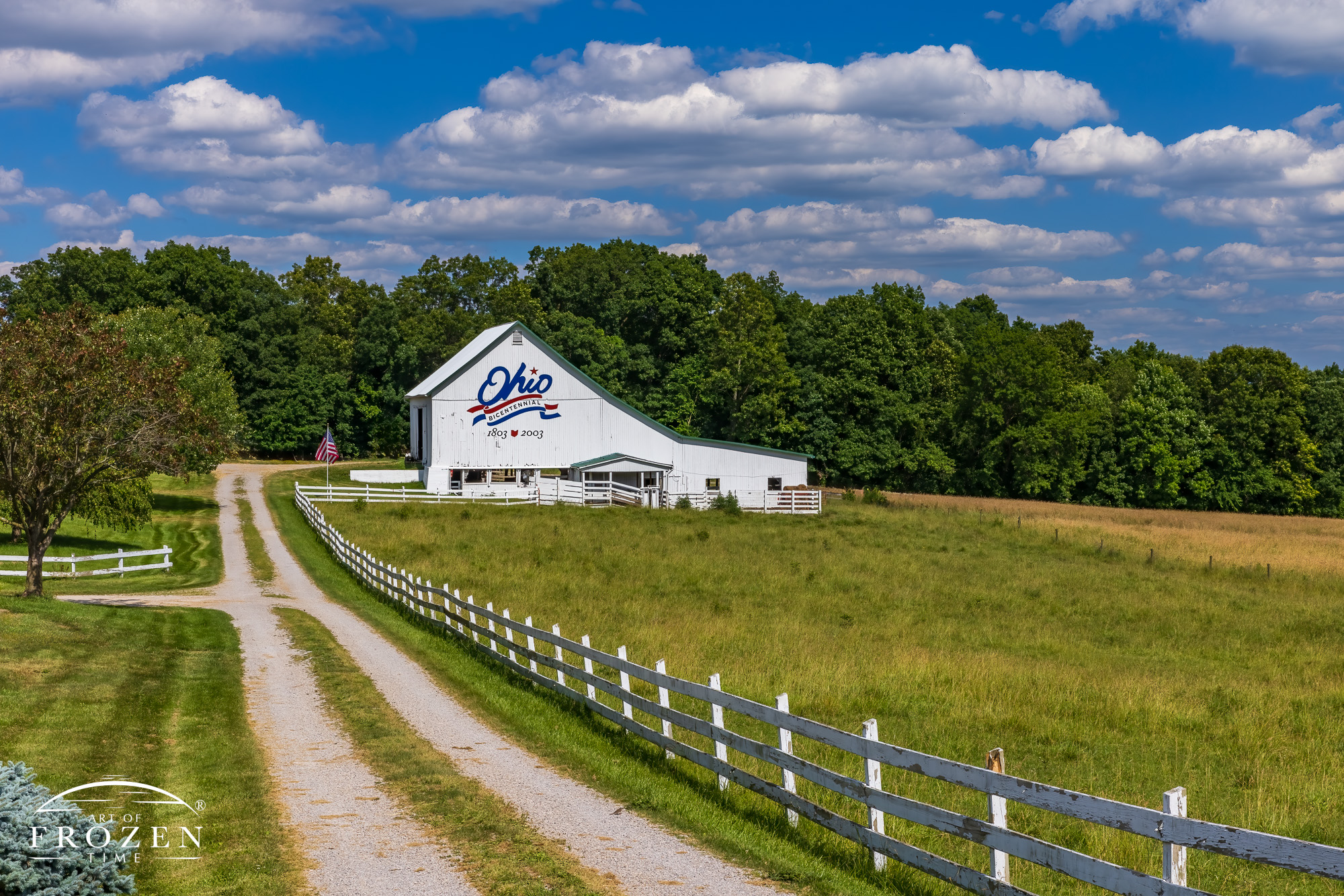 A proud white barn along a country road adorned with the Ohio Bicentennial logo making for an impressive Ohio fine art photography