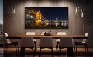 An AI room visualization featuring my fine art print of Roebling Bridge at night with its warm lights that leads the eye across the Ohio River towards the colorful Cincinnati Skyline