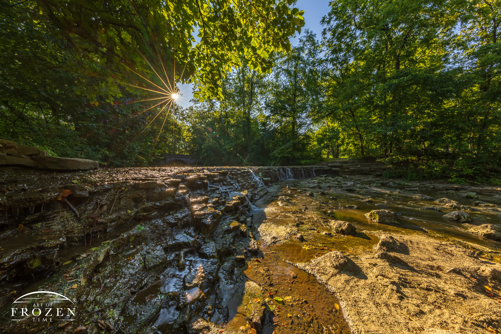 A summer morning view of the waterfall at Sharon Woods near Sharonville Ohio where trees gently filtered the golden light