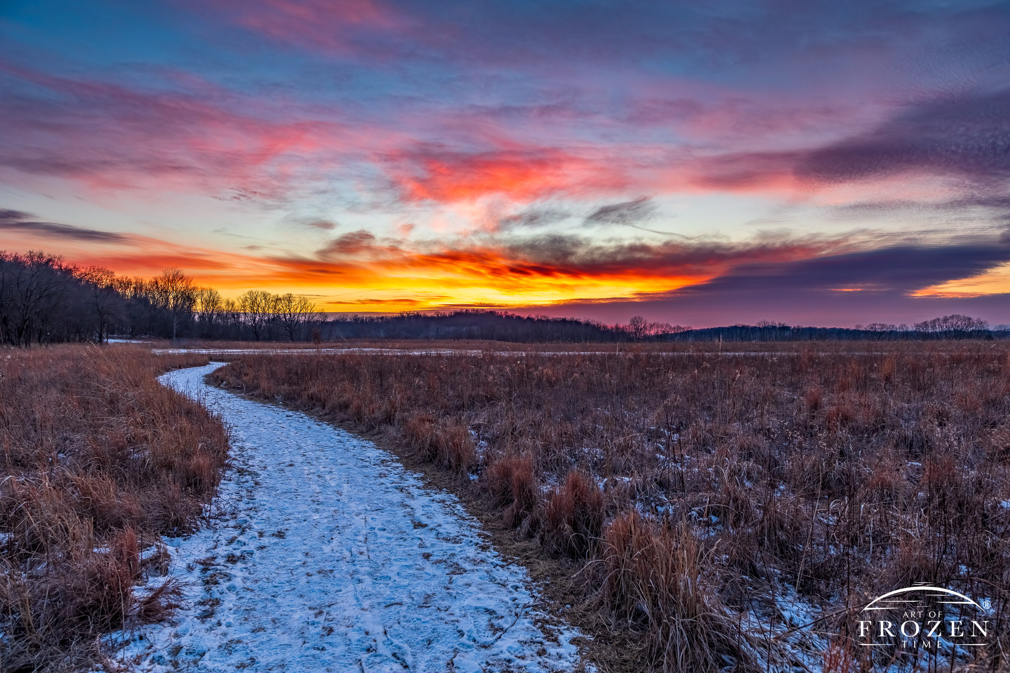 A snowy prairie path at Morris Reserve, near Bellbrook Ohio that forms a leading line as it meanders towards the horizon.