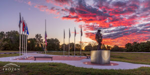 Sugarcreek Township Veterans Memorial During a Colorful Blue Hour No. 17 | Art of Frozen Time Sugarcreek Veterans Memorial at sunrise in Bellbrook Ohio with American and military flags and Pee Wee Martin statue under colorful clouds