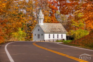 Fine art photo of Todds Community Church in Morgan County Ohio, a white clapboard Gothic-style church with pointed-arch windows and an octagonal steeple rising above autumn-colored hillsides.